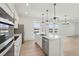 Bright, open kitchen featuring a large center island, stainless appliances, and plentiful natural light at 16544 Silver Brook Way, Winter Garden, FL 34787