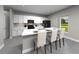 Modern kitchen featuring white cabinets, a large island, and stainless steel appliances at 16544 Silver Brook Way, Winter Garden, FL 34787