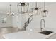 Modern kitchen featuring a sink and stainless steel appliances adjacent to an open staircase at 16544 Silver Brook Way, Winter Garden, FL 34787