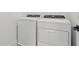 White, front-loading washer and dryer at 16544 Silver Brook Way, Winter Garden, FL 34787
