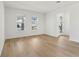 Bright living room with wood flooring, white walls, and natural light from the windows at 16544 Silver Brook Way, Winter Garden, FL 34787