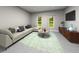 Bright living room featuring a large sectional sofa, modern decor, and plenty of natural light at 16544 Silver Brook Way, Winter Garden, FL 34787