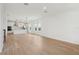Open-concept living space with wood floors and a kitchen with stainless appliances at 16544 Silver Brook Way, Winter Garden, FL 34787