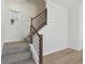 Staircase with modern wood and iron railing and neutral carpet at 16544 Silver Brook Way, Winter Garden, FL 34787