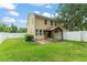 Spacious backyard featuring a manicured lawn and a charming pergola covered patio, perfect for outdoor entertaining at 1774 Peterson Pl, Sanford, FL 32773