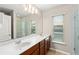 Bright bathroom featuring a double sink vanity, large mirror, and walk-in shower at 1774 Peterson Pl, Sanford, FL 32773