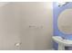Bathroom featuring a pedestal sink, oval mirror, and towel rack at 1774 Peterson Pl, Sanford, FL 32773
