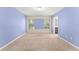 Carpeted bedroom with two large windows and blue accent walls at 1774 Peterson Pl, Sanford, FL 32773