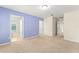 Carpeted bedroom with blue accent walls, natural light, and multiple doorways at 1774 Peterson Pl, Sanford, FL 32773