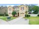 Two-story tan home with front yard landscaping and driveway leading to garage at 1774 Peterson Pl, Sanford, FL 32773