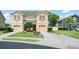 Traditional-style townhome featuring a well-manicured lawn, charming shutters, and a private driveway and garage at 1774 Peterson Pl, Sanford, FL 32773