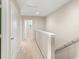 Upstairs hallway featuring neutral carpet, white trim, and access to rooms at 1774 Peterson Pl, Sanford, FL 32773