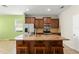 Kitchen with island, stainless steel appliances, and wooden cabinetry at 1774 Peterson Pl, Sanford, FL 32773