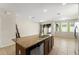 Kitchen island with stone counter and bar stools in a well-lit space at 1774 Peterson Pl, Sanford, FL 32773