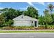Charming single-story home featuring a two-car garage, lush landscaping, and neutral-colored exterior at 1834 Waggoner St, Kissimmee, FL 34744