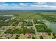 Areal view pinpointing the home in a serene location with lush greenery and a nearby lake at 19204 Paddock St, Orlando, FL 32833