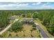 Sprawling property featuring a charming single-story home, lush landscaping, and a long, private driveway at 19204 Paddock St, Orlando, FL 32833