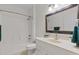 Cozy bathroom features a shower-tub combo and a single sink vanity with a large framed mirror at 19204 Paddock St, Orlando, FL 32833