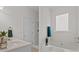 Bright bathroom features a soaking tub, a single vanity, and a glass-enclosed shower at 19204 Paddock St, Orlando, FL 32833