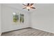 Bedroom featuring a ceiling fan and natural light with views of the surrounding trees at 19204 Paddock St, Orlando, FL 32833