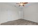 Neutral bedroom featuring hard surface flooring, ceiling fan, and two doors at 19204 Paddock St, Orlando, FL 32833