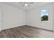An empty bedroom with light wood floors and natural light streaming through the window at 19204 Paddock St, Orlando, FL 32833