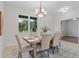 Cozy dining room with a wooden table set for six, a chandelier, and a bright window view at 19204 Paddock St, Orlando, FL 32833