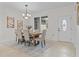 Elegant dining room featuring a wood table, upholstered chairs, and a decorative rug on tile flooring at 19204 Paddock St, Orlando, FL 32833