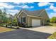 Charming home featuring a clean two-car garage, dark shutters, and a well-maintained yard at 19204 Paddock St, Orlando, FL 32833