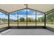 A screened lanai providing scenic views of the backyard with ample sunlight at 19204 Paddock St, Orlando, FL 32833