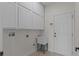 The laundry room offers storage cabinets, a utility sink, and access to the exterior at 19204 Paddock St, Orlando, FL 32833