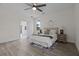 Well-lit main bedroom with light laminate floors, neutral decor, and an en-suite bathroom at 19204 Paddock St, Orlando, FL 32833