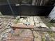Damaged backyard patio with uneven bricks, exposed dirt, and overgrown plants at 2120 Lakebreeze Way, Deltona, FL 32738