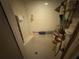 Shower stall featuring white tile, grab bar, handheld sprayer, overhead shower, and storage caddy at 2120 Lakebreeze Way, Deltona, FL 32738