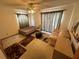 This bedroom offers a ceiling fan, a twin sized bed and a comfy sofa at 2120 Lakebreeze Way, Deltona, FL 32738