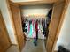 Bedroom closet with louvered doors featuring clothing on hangers at 2120 Lakebreeze Way, Deltona, FL 32738
