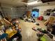 View of the garage filled with stored household items and debris at 2120 Lakebreeze Way, Deltona, FL 32738