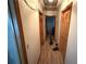 Hallway leading to bedrooms with wooden trim at 2120 Lakebreeze Way, Deltona, FL 32738