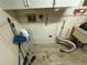 Close-up of a laundry room area featuring connections and cleaning supplies and vinyl flooring at 2120 Lakebreeze Way, Deltona, FL 32738