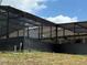 Pool enclosure showcasing dark metal framing and providing coverage over the outdoor area at 2120 Lakebreeze Way, Deltona, FL 32738