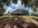 An exterior wide shot of the screened in pool with house in background at 2120 Lakebreeze Way, Deltona, FL 32738