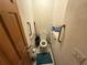 Small powder room with toilet, toilet paper holder, and grab bars at 2120 Lakebreeze Way, Deltona, FL 32738