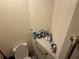 Small toilet area with tiled shelf and grab bars at 2120 Lakebreeze Way, Deltona, FL 32738