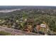 An aerial view of property outlined in red with mature tree coverage, located near commercial and residential areas at 2214 Rouse Rd, Orlando, FL 32817