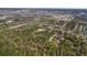 A serene aerial view of land with dense trees, a community, and access to nearby bodies of water at 2214 Rouse Rd, Orlando, FL 32817