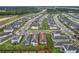 Aerial view of a community featuring closely arranged homes and a view of a green area nearby at 2241 Mystic Maze Ln, Minneola, FL 34715