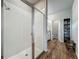 Bathroom featuring a glass-enclosed shower, wood tile floors, built-in storage and granite vanity at 2241 Mystic Maze Ln, Minneola, FL 34715