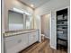 Bathroom showcasing double vanity with granite countertops and a linen closet at 2241 Mystic Maze Ln, Minneola, FL 34715
