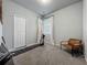 Bedroom featuring neutral walls, plush carpet, a modern chair, and a golf simulator at 2241 Mystic Maze Ln, Minneola, FL 34715