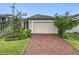 Charming single-Gathering home featuring a two-car garage, landscaped yard, and a beautiful brick driveway at 2241 Mystic Maze Ln, Minneola, FL 34715